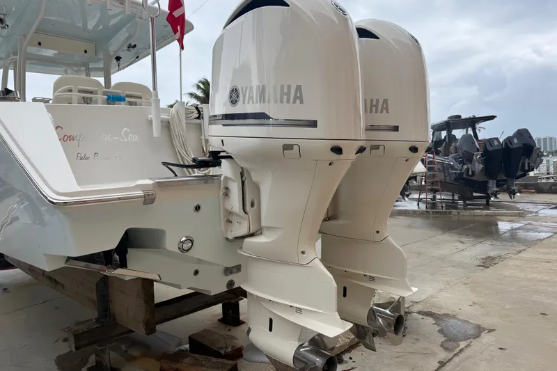 Slide: The Image of 2012 Jupiter 34 FS boat with twin Yamaha outboard engines on a dock. - 20