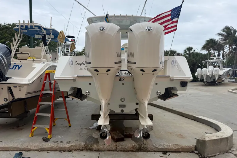 Slide: The Image of 2012 Jupiter 34 FS boat with twin Yamaha outboard engines at a marina. - 21