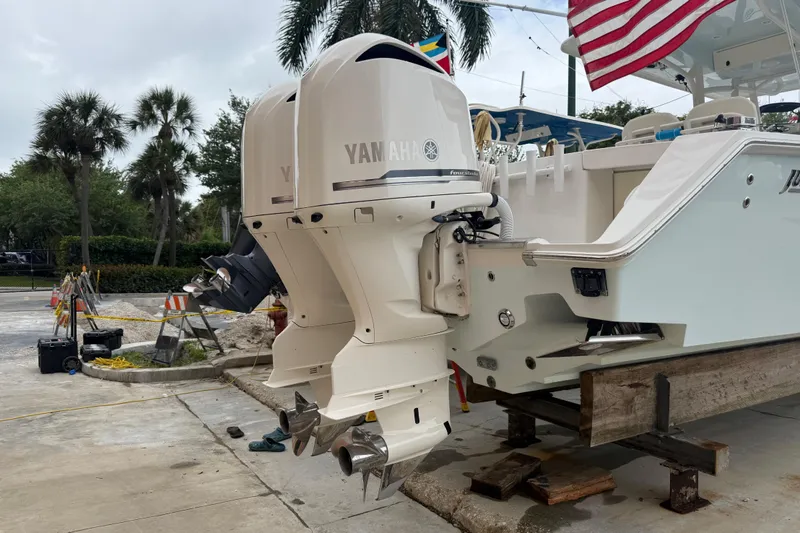 Slide: The Image of 2012 Jupiter 34 FS boat with twin Yamaha outboard motors on a maintenance dock. - 22