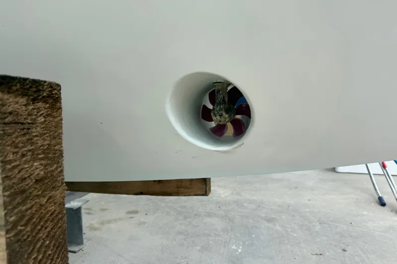 Slide: The Image of Bow thruster on a 2012 Jupiter 34 FS boat, displayed on a wooden stand. - 24
