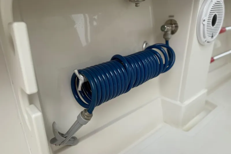 Slide: The Image of Coiled blue hose on 2012 Jupiter 34 FS boat, mounted on white interior panel. - 26