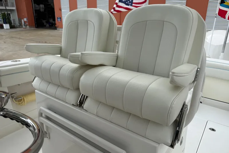 Slide: The Image of Luxury seating on 2012 Jupiter 34 FS boat with white cushioned armchairs. - 27