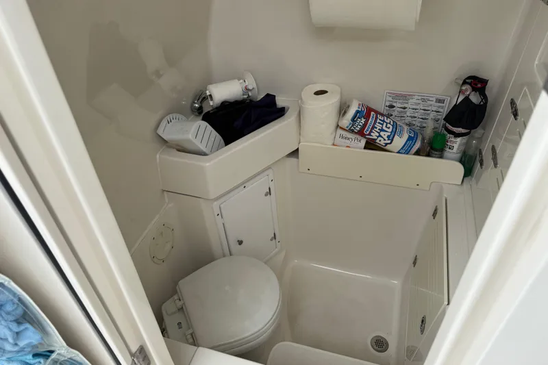 Slide: The Image of Compact bathroom in 2012 Jupiter 34 FS boat with toilet and storage shelves. - 28