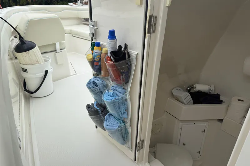 Slide: The Image of Interior of a 2012 Jupiter 34 FS boat with organized storage and compact bathroom. - 29