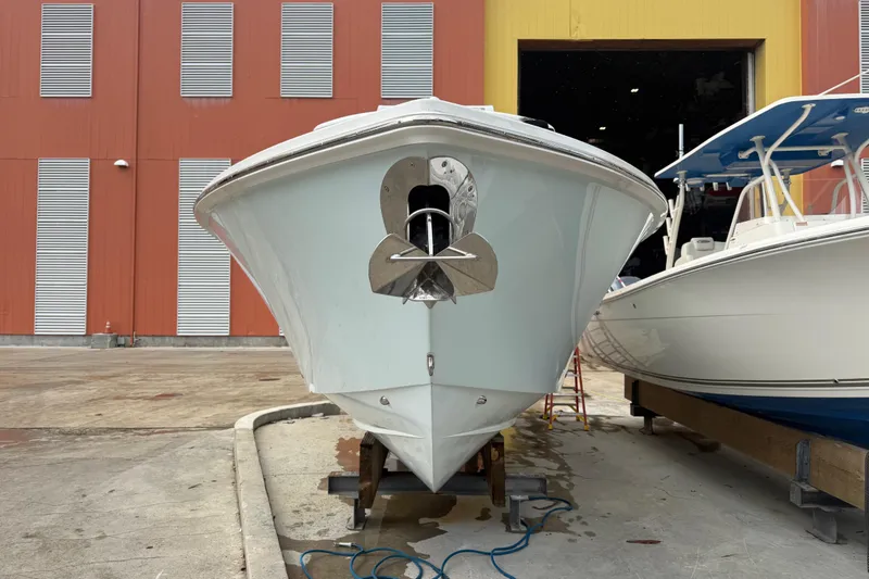 Slide: The Image of 2012 Jupiter 34 FS boat in a marina, front view, with anchor and adjacent vessel. - 3