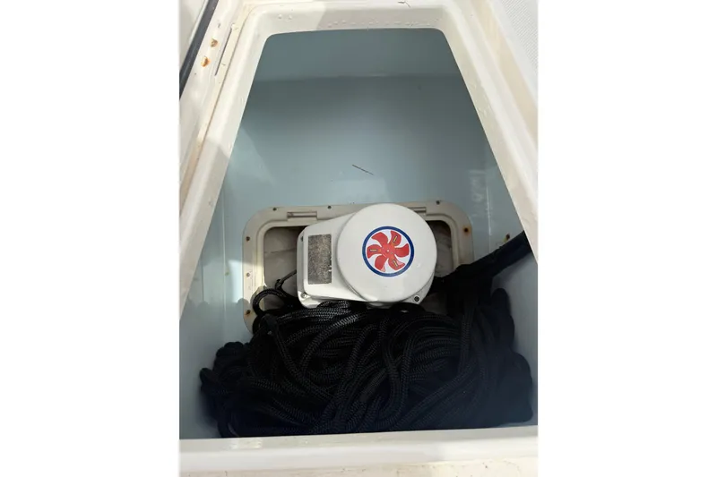 Slide: The Image of Anchor storage compartment on a 2012 Jupiter 34 FS boat with coiled rope. - 31