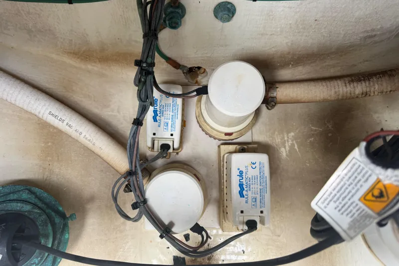 Slide: The Image of Bilge pump system in a 2012 Jupiter 34 FS boat, featuring Rule-A-Matic Plus components. - 33