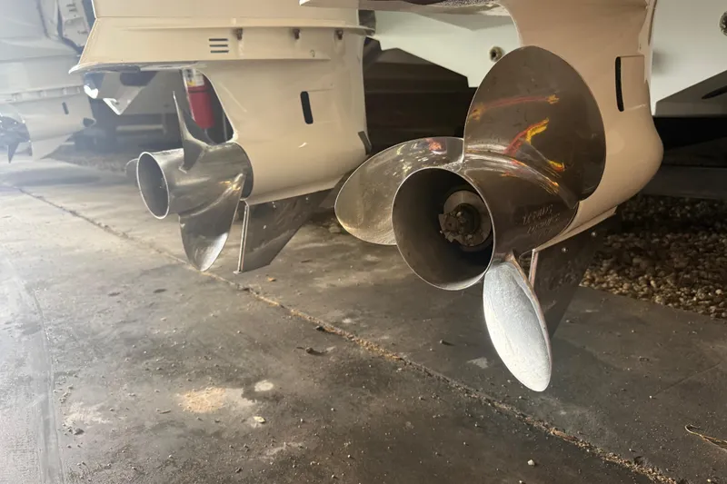 Slide: The Image of Close-up of 2012 Jupiter 34 FS boat propellers in a garage setting. - 34