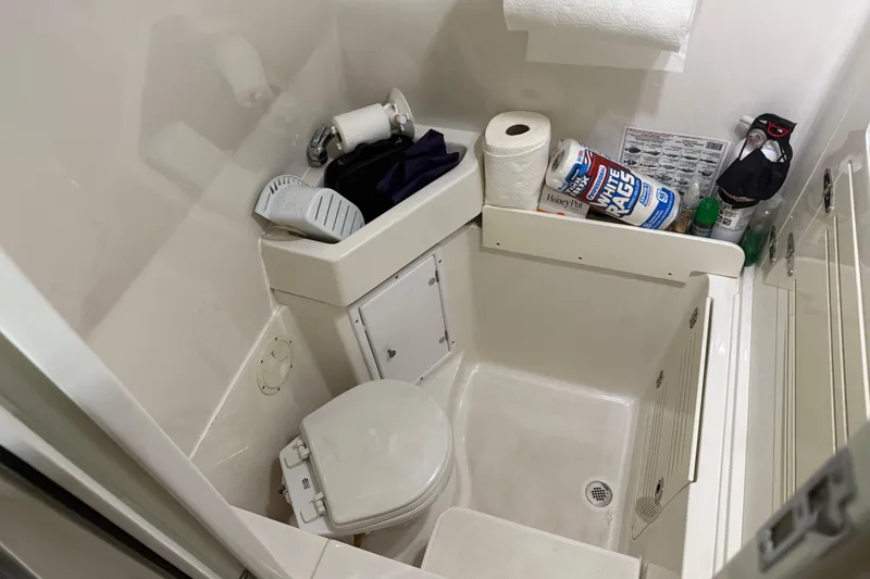 Slide: The Image of Compact bathroom in a 2012 Jupiter 34 FS boat, featuring essential toiletries and storage. - 36