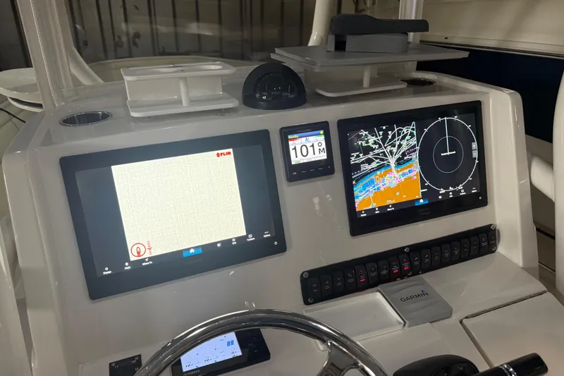 Slide: The Image of Control panel of a 2012 Jupiter 34 FS boat with navigation screens and controls. - 5