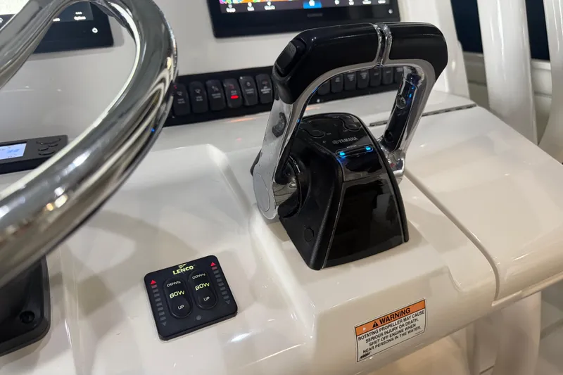 Slide: The Image of Control panel of a 2012 Jupiter 34 FS boat with steering wheel and throttle. - 9
