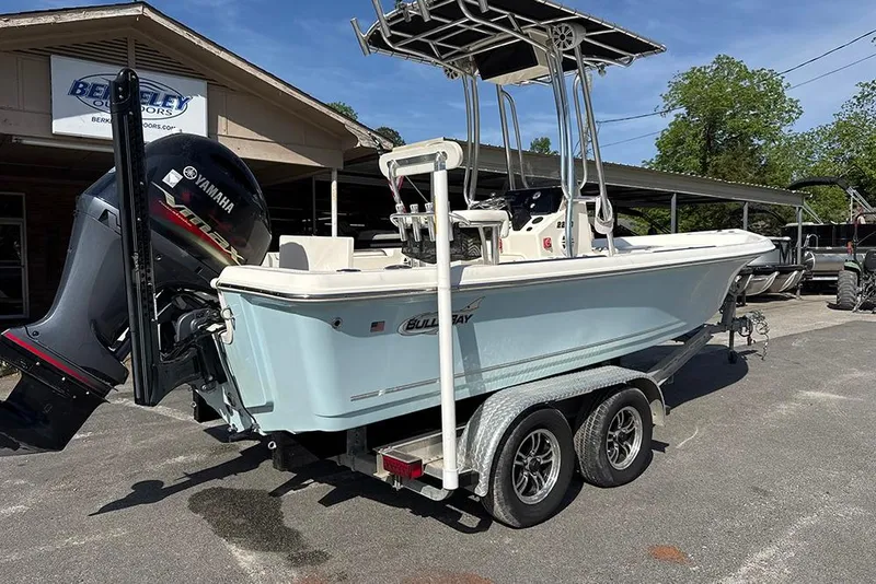 Slide: The Image of 2021 Bulls Bay 2200 boat on trailer with Yamaha outboard motor, parked outdoors. - 11