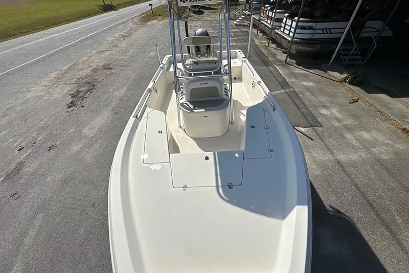 Slide: The Image of 2021 Bulls Bay 2200 boat on a roadside, showcasing spacious deck and seating. - 17