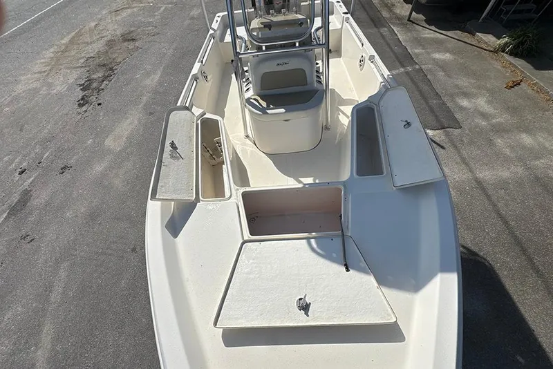 Slide: The Image of 2021 Bulls Bay 2200 boat deck with open storage compartments. - 18