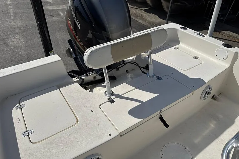 Slide: The Image of 2021 Bulls Bay 2200 boat interior with Yamaha engine, featuring storage compartments and seating. - 24