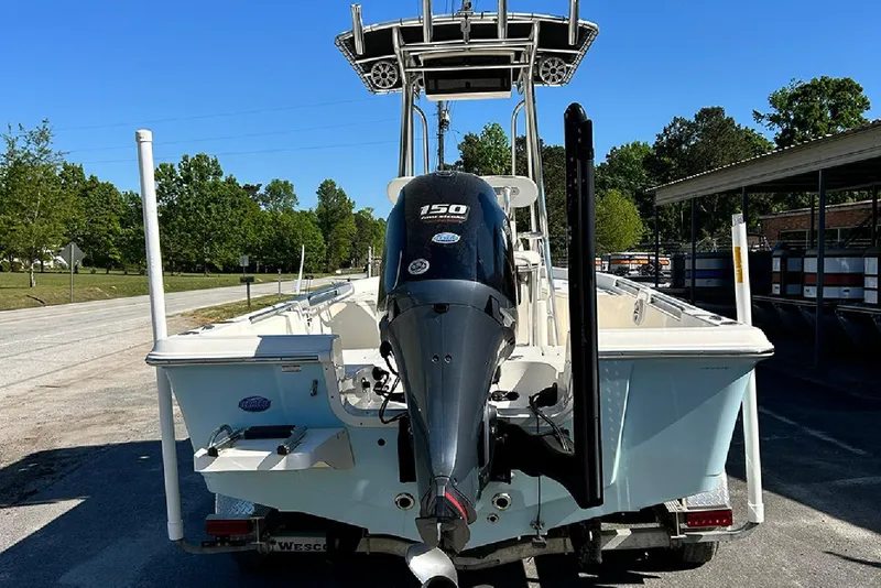 Slide: The Image of 2021 Bulls Bay 2200 boat with 150 HP engine, parked outdoors on a sunny day. - 5