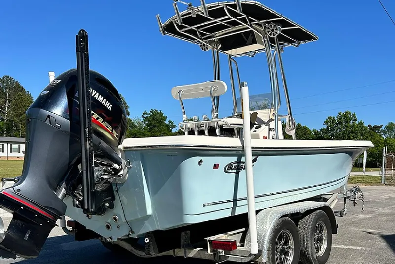 Slide: The Image of 2021 Bulls Bay 2200 boat with Yamaha engine on a trailer, under clear blue sky. - 6