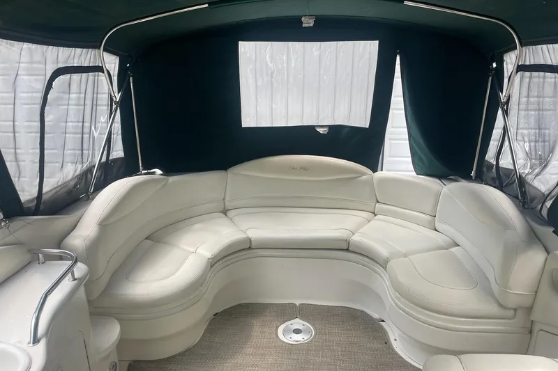 Slide: The Image of Interior of a 2001 Sea Ray 280 Sun Sport boat with white leather seating. - 10