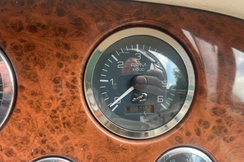 Slide: The Image of Tachometer of 2001 Sea Ray 280 Sun Sport boat, showing RPM and wood grain panel. - 13