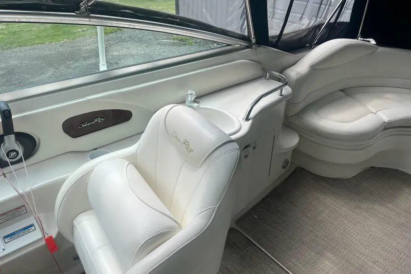 Slide: The Image of Interior of a 2001 Sea Ray 280 Sun Sport boat with white seating and helm. - 14