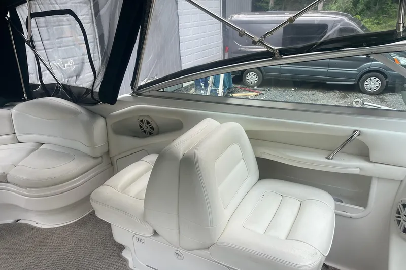Slide: The Image of Interior of 2001 Sea Ray 280 Sun Sport boat with white seating and windows. - 15