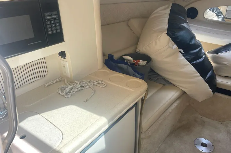 Slide: The Image of Interior of 2001 Sea Ray 280 Sun Sport with seating, cushions, and a microwave. - 16