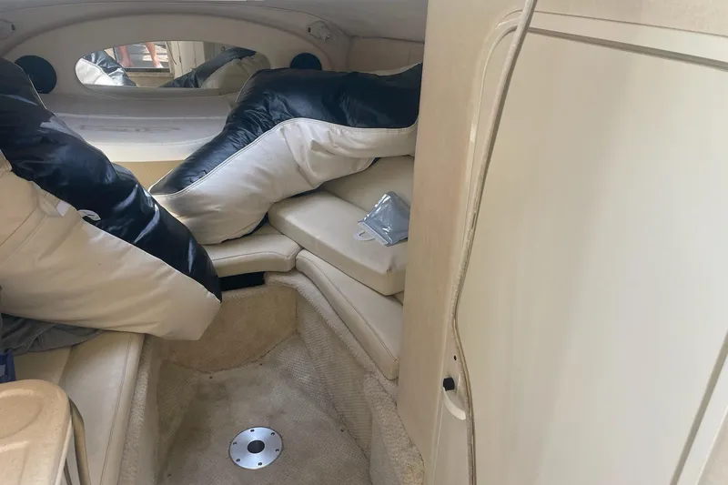 Slide: The Image of Interior cabin of a 2001 Sea Ray 280 Sun Sport boat with cushions and seating. - 17