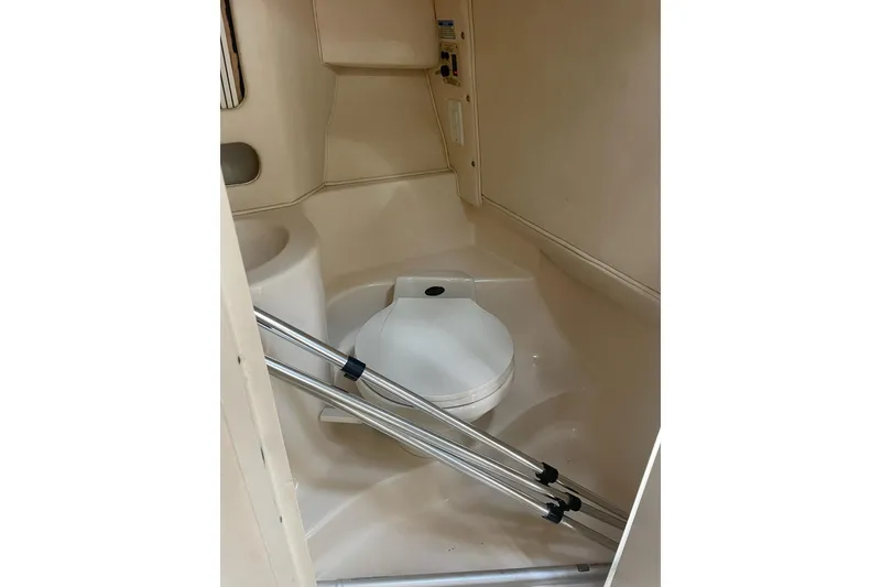 Slide: The Image of Interior of 2001 Sea Ray 280 Sun Sport boat, featuring compact bathroom facilities. - 19