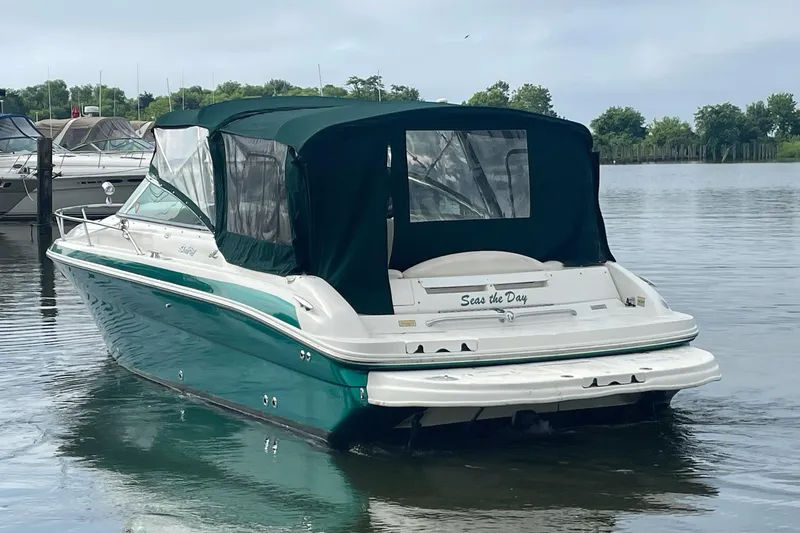 Slide: The Image of 2001 Sea Ray 280 Sun Sport boat with green canopy on calm water. - 3