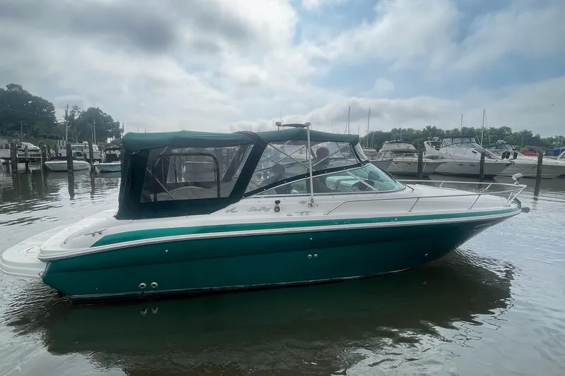 Slide: The Image of 2001 Sea Ray 280 Sun Sport boat docked in a marina under cloudy skies. - 6
