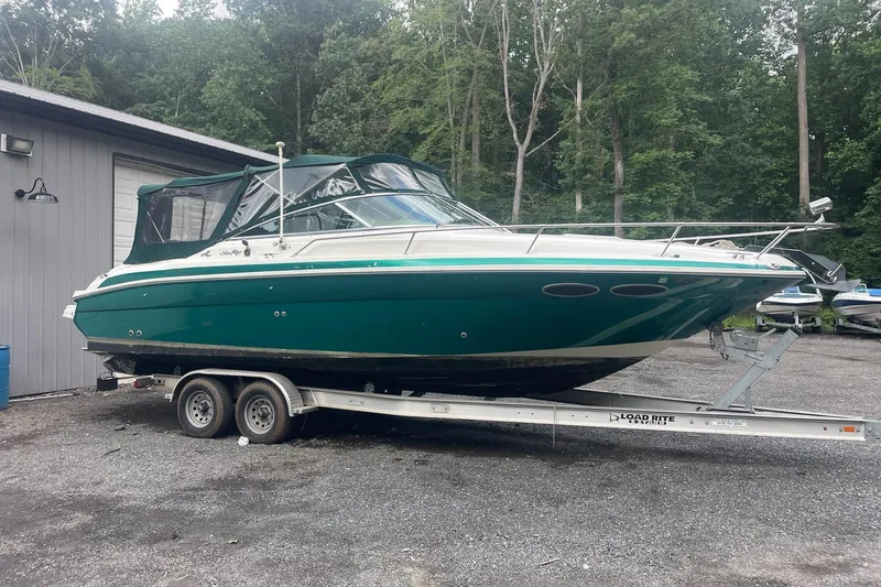 Slide: The Image of 2001 Sea Ray 280 Sun Sport boat on trailer, parked outdoors near a building. - 7