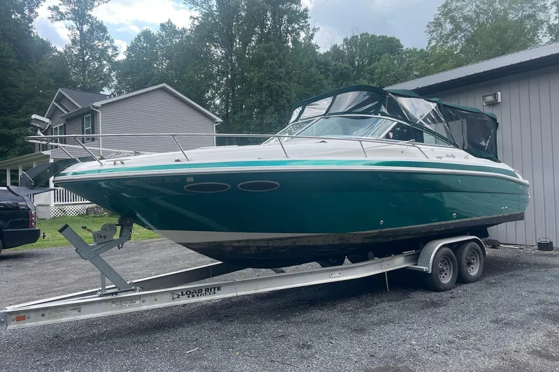Slide: The Image of 2001 Sea Ray 280 Sun Sport boat on trailer, parked outdoors near a house. - 8