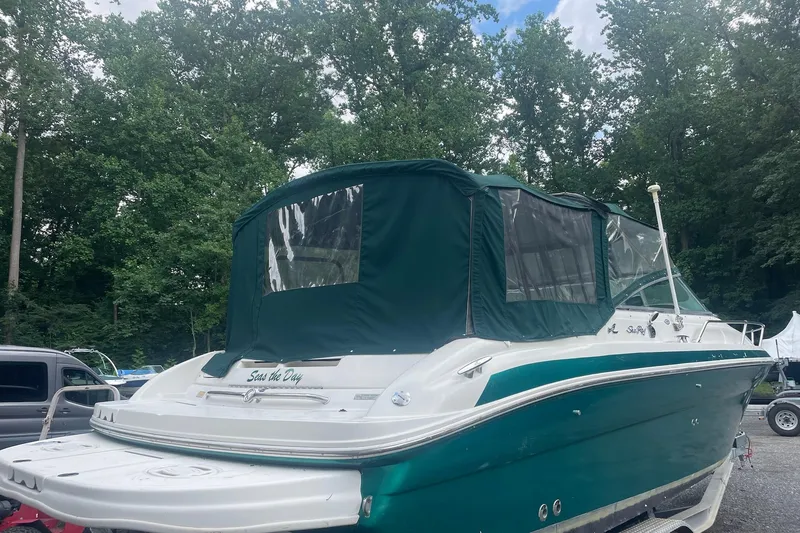Slide: The Image of 2001 Sea Ray 280 Sun Sport boat with green canopy, parked outdoors. - 9