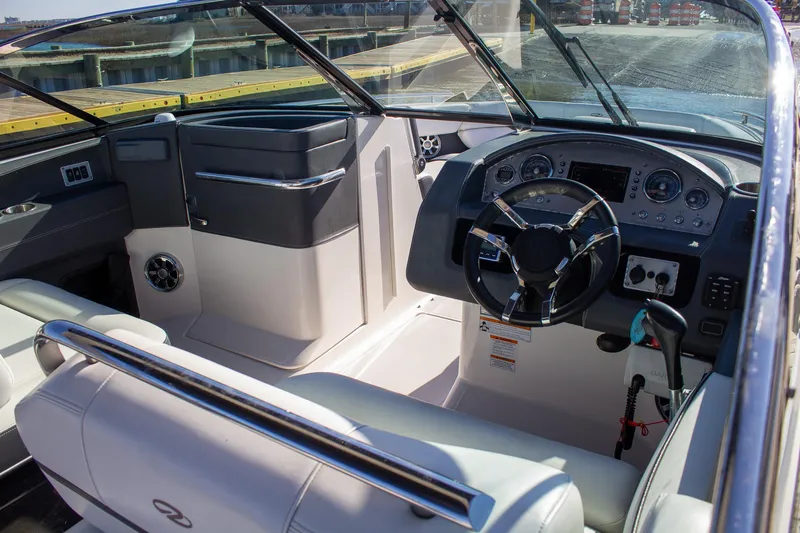 Slide: The Image of 2015 Regal 2800 boat interior with steering wheel and seating area. - 12