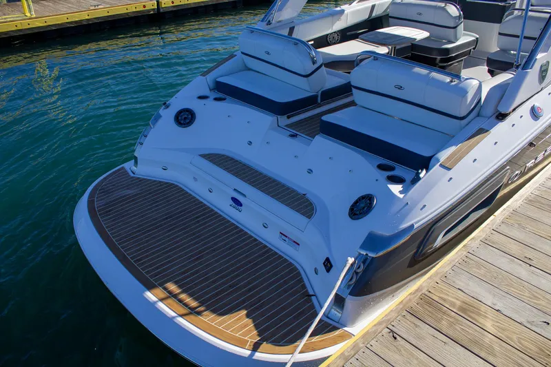 Slide: The Image of 2015 Regal 2800 boat docked, featuring spacious seating and sleek design. - 13