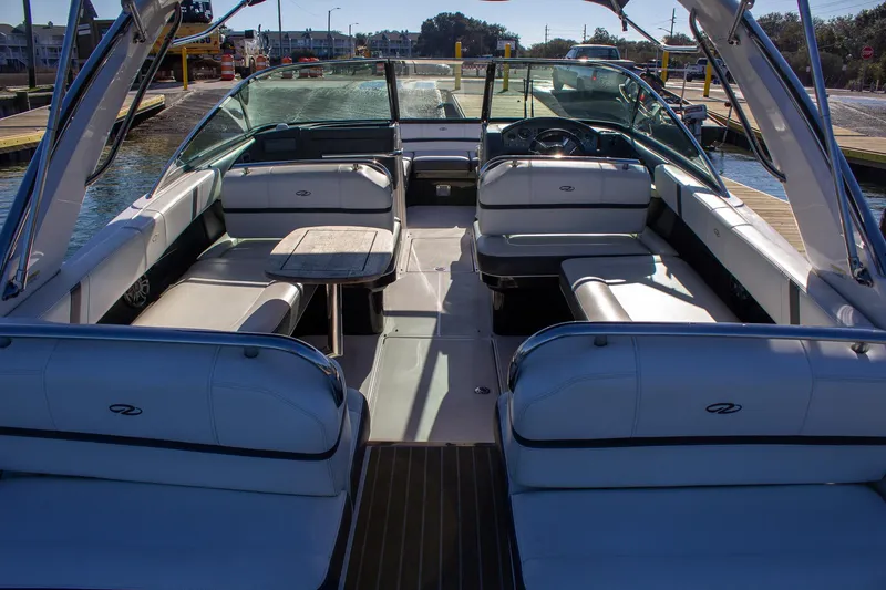 Slide: The Image of 2015 Regal 2800 boat interior with white seating and a wooden table. - 14