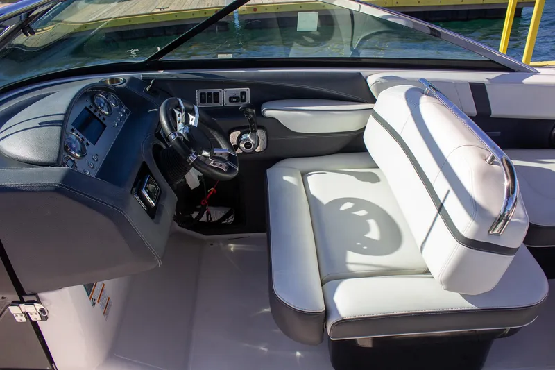 Slide: The Image of Interior of 2015 Regal 2800 boat with steering wheel and seating. - 16