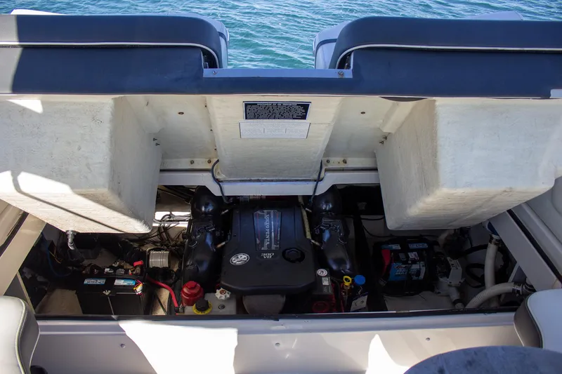 Slide: The Image of Engine compartment of a 2015 Regal 2800 boat, showcasing mechanical components and battery. - 17