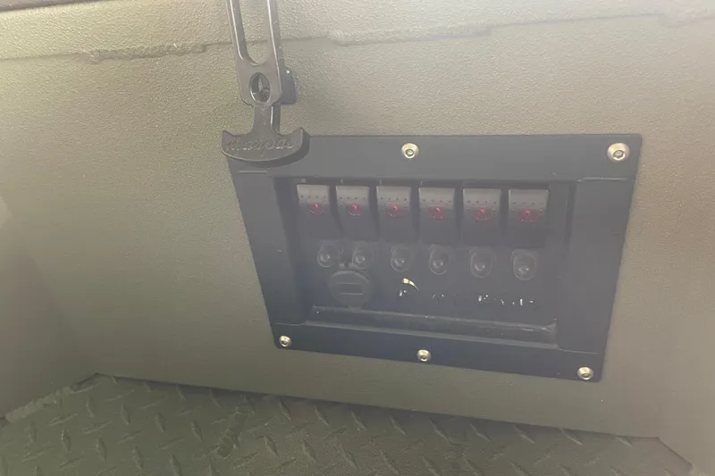 Slide: The Image of Control panel on 2026 Reaper Boats 653 Timber Reaper, featuring multiple switches and a key holder. - 10