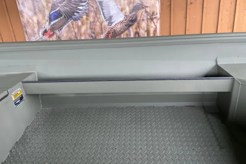 Slide: The Image of Interior of 2026 Reaper Boats 653 Timber Reaper with textured flooring and duck hunting decor. - 15