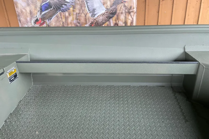 Slide: The Image of 2026 Reaper Boats 653 Timber Reaper interior with textured flooring and wildlife artwork. - 16