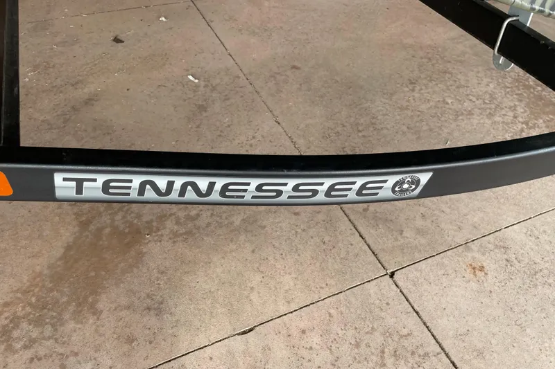 Slide: The Image of 2026 Reaper Boats 653 Timber Reaper trailer with Tennessee branding on concrete surface. - 18