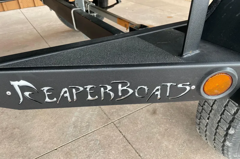 Slide: The Image of Reaper Boats 653 Timber Reaper 2026 trailer with logo and orange reflector. - 19