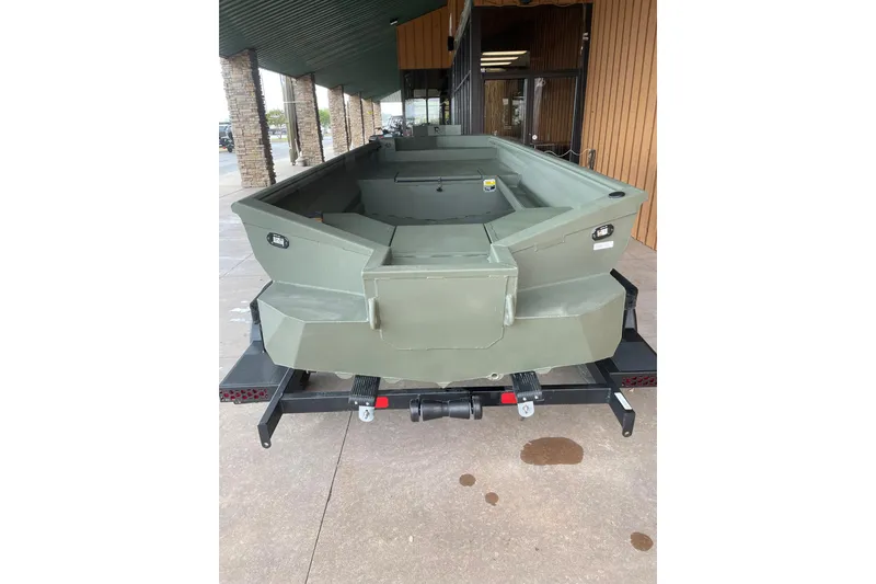 Slide: The Image of 2026 Reaper Boats 653 Timber Reaper, green hull, on trailer, outdoor display. - 8