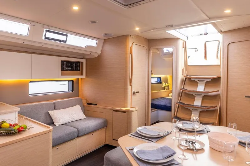 Slide: The Image of Modern interior of Dufour 44 sailboat with dining area and cozy seating. - 18