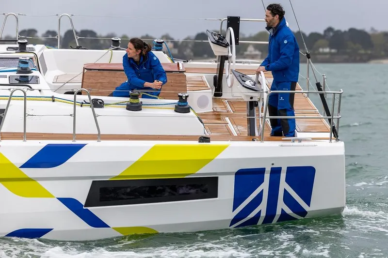 Slide: The Image of Dufour 44 sailboat with crew sailing on open water. - 3