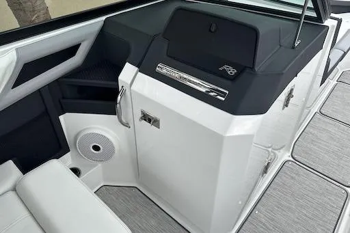 Slide: The Image of 2024 Cobalt R8 boat interior with sleek design, featuring modern dashboard and speaker system. - 11
