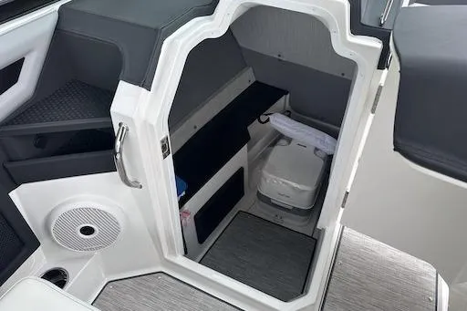 Slide: The Image of 2024 Cobalt R8 boat interior with compact cabin and modern amenities. - 13