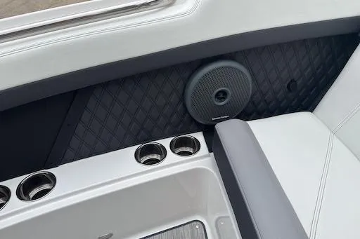 Slide: The Image of 2024 Cobalt R8 boat interior with speaker and cup holders, featuring sleek design elements. - 21