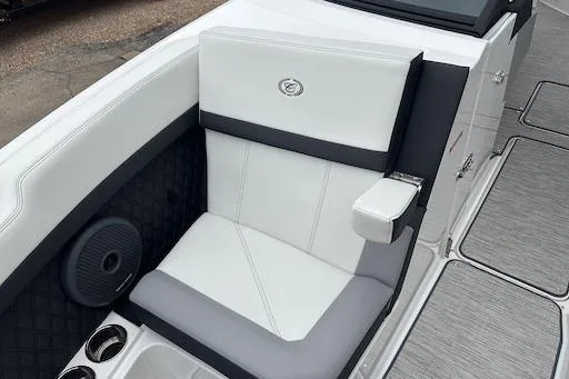 Slide: The Image of 2024 Cobalt R8 boat seat with white and gray upholstery, featuring cup holders and speaker. - 22